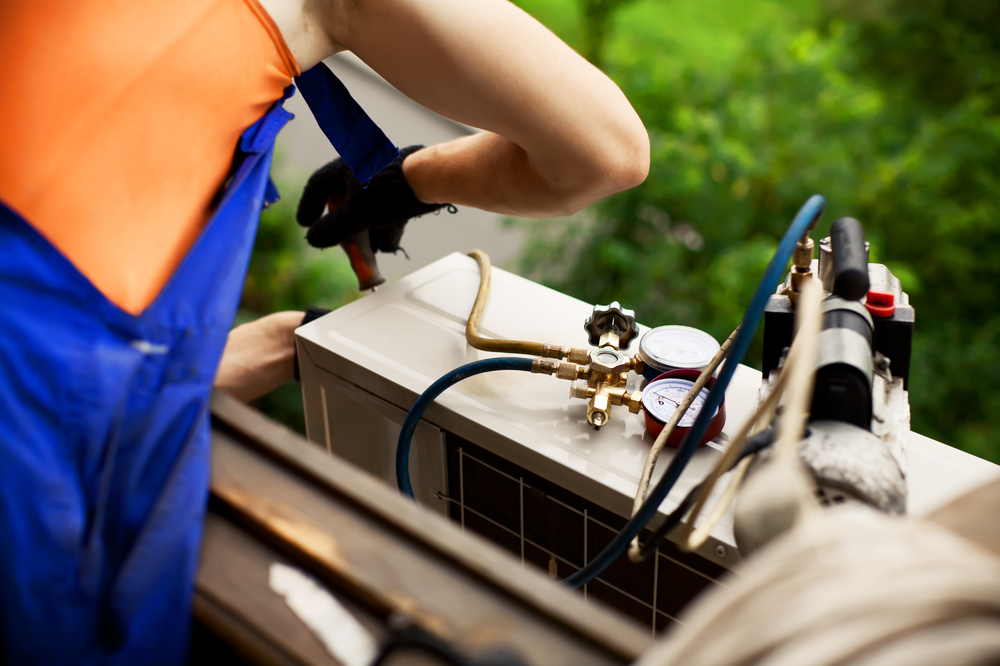 ac unit being worked on by technician